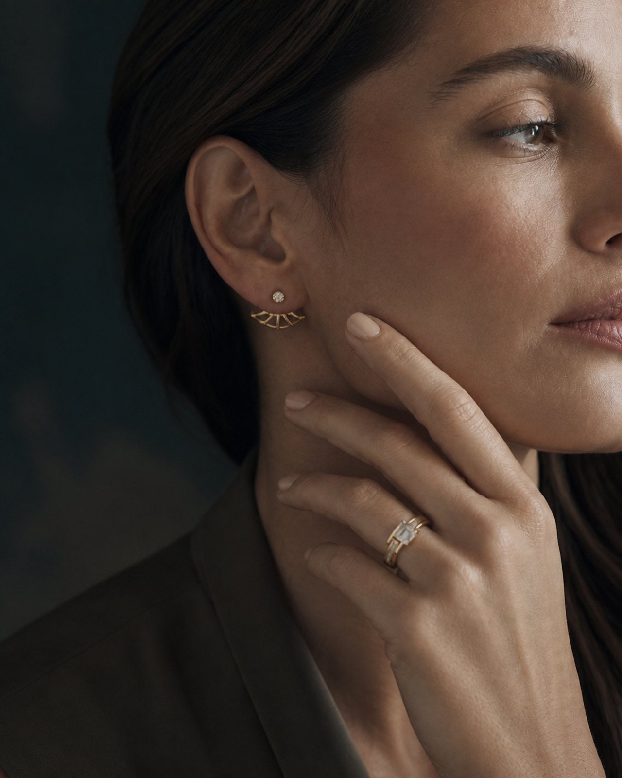Diamond ear jacket and emerald-cut ring in gold, worn